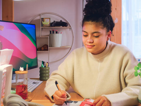 Young lady reading the guide to becoming yourself at her desk