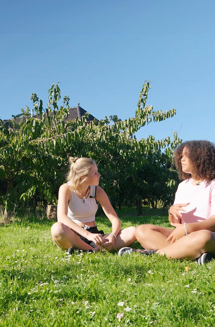 two young ladies discussing on the grass from Between Teenagers series