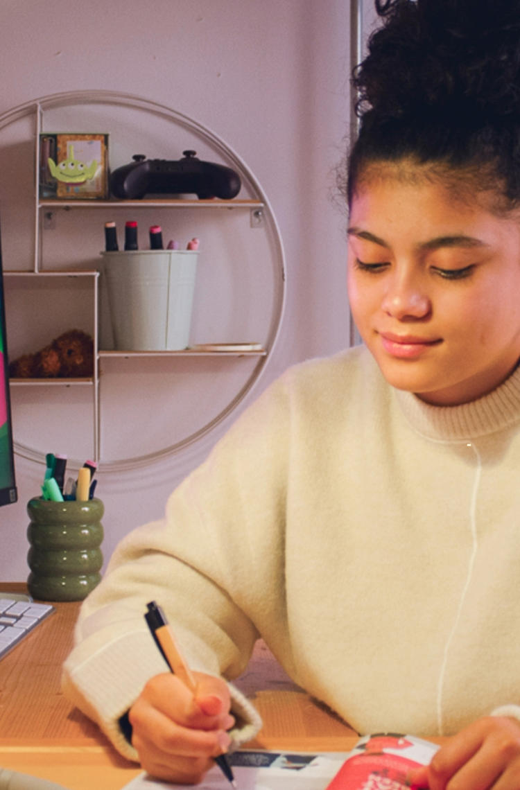 Young lady reading the guide to becoming yourself at her desk Young lady reading the guide to becoming yourself at her desk